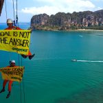 Krabi, Thailand. Greenpeace climbing activists hangs banner with a message of "STOP COAL (or COAL IS NOT THE ANSWER) at Rairay beach, admonishing government stop deceptive energy crisis discourse to go to new coal power plant. Photo by Athit Perawongmetha/Greenpeace.